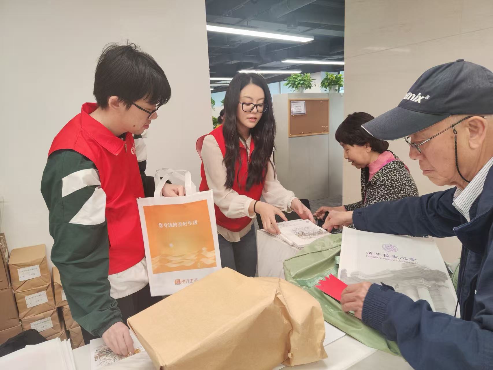 20260424-115周年校庆志愿服务-居茗轩-志愿者王卓琳为校友分发物资.jpg